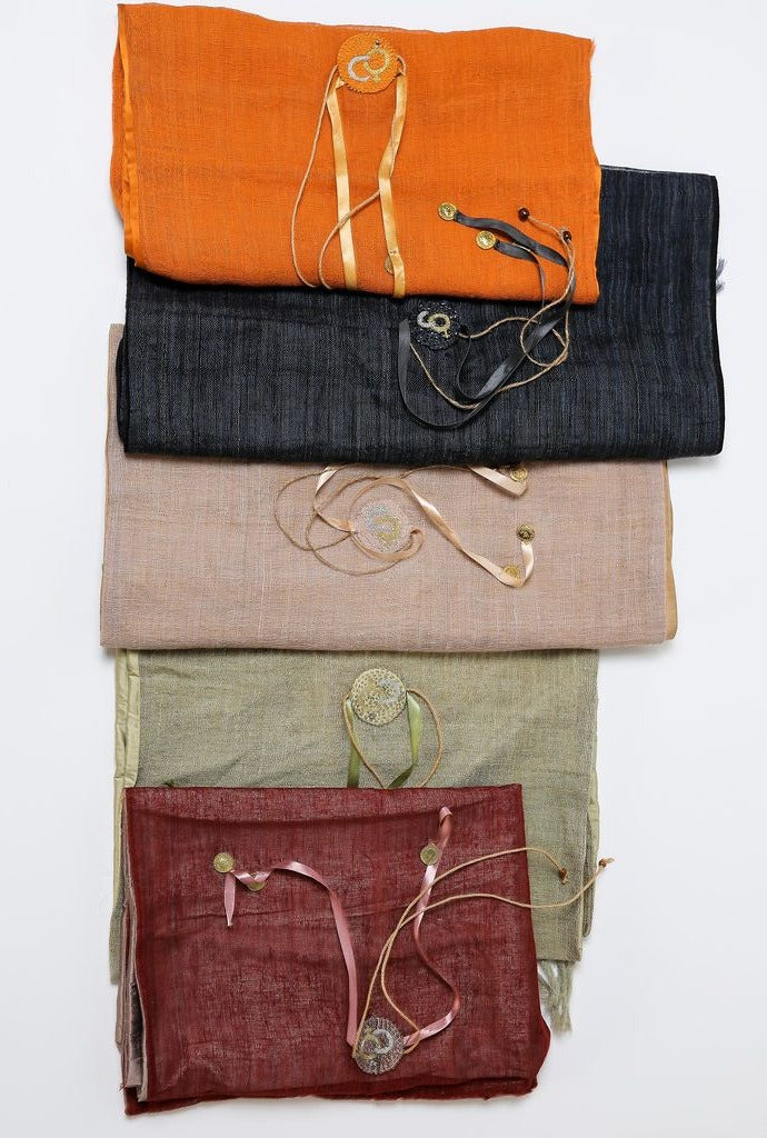 Duurzame, handgemaakte, betekenisvolle Plain sjaals die elegant gedrapeerd zijn en een intrigerend patroon van verweven kleuren en texturen laten zien