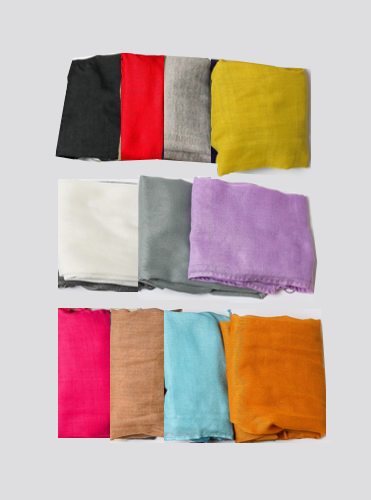 Duurzame, handgemaakte, betekenisvolle Luxe sjaals die elegant gedrapeerd zijn en een intrigerend patroon van verweven kleuren en texturen laten zien
